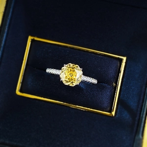 Macro shot of 2.5 carat octagonal yellow gemstone ring in a deep blue velvet jewelry box