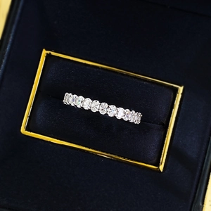 Macro shot of S925 sterling silver eternity ring with full diamonds in a luxury gift box