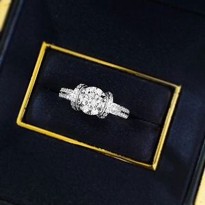 Elegant S925 silver engagement ring with round center diamond in a blue velvet box
