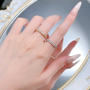 Close-up of gold and silver S925 sterling silver eternity rings with full pave diamonds