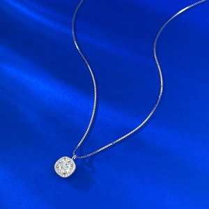 Macro shot of cushion-cut halo moissanite pendant with elegant silver box chain detail