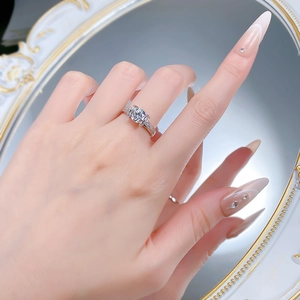 Close-up of S925 silver ring with a round diamond worn by a model in front of a mirror