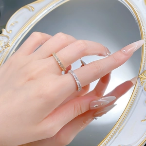 Detailed view of silver and gold plated eternity rings with pave cubic zirconia accents