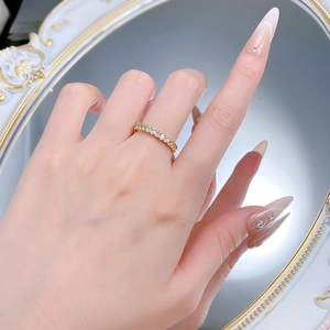 Eternity ring in S925 silver with full diamonds shown on finger with classic decor