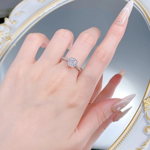 Macro view of 2.5 carat octagonal cut solitaire ring with pave set stones on hand