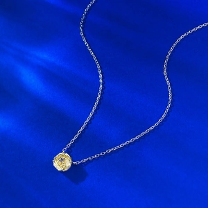 Detailed close-up of a pale yellow rose-shaped gemstone pendant on a silver S925 chain