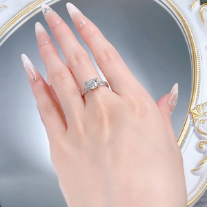 Detailed view of an S925 silver ring featuring a round diamond on a hand with mirror