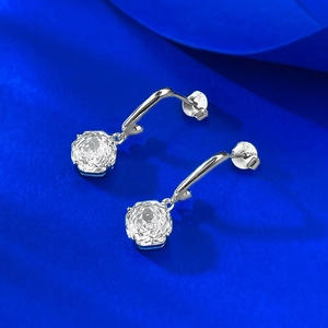 Detailed view of S925 sterling silver stamp on the earring back against blue silk background