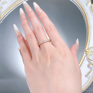 Close-up of a slim gold S925 silver ring with full diamonds on a model's hand