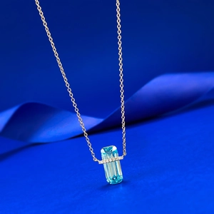 Elegant gold S925 silver necklace featuring a rectangular blue topaz pendant on silk