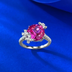 Macro detail of S925 silver ring featuring a large pink lotus-cut gemstone and floral accents