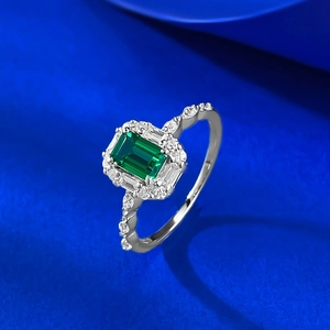 Elegant S925 silver ring featuring emerald-cut green stone with halo diamond setting