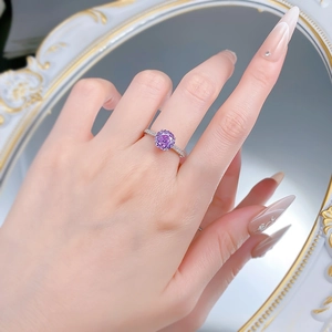 Macro detail of a purple rose-cut gem ring with diamond-encrusted silver band