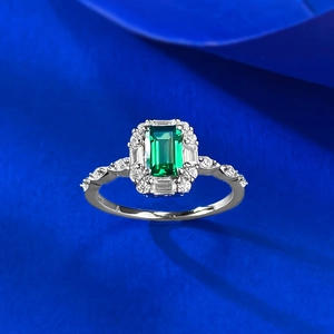 Macro view of S925 silver ring with emerald cut green stone and brilliant halo details
