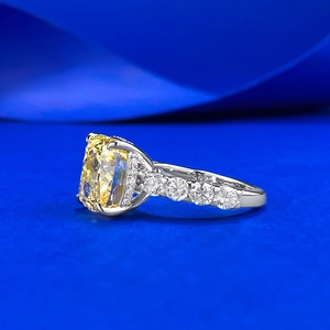 S925 silver ring with 9x10mm yellow cushion-cut diamond and pavé side stones on blue satin