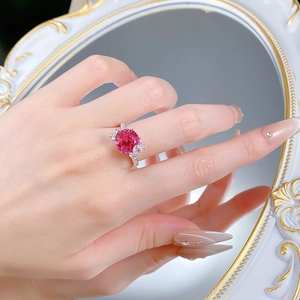 Macro detail of S925 silver ring featuring rose pink lotus cut stone and butterfly accents