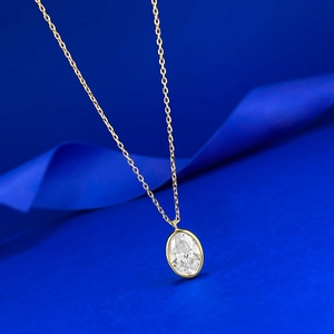 Détail du collier avec diamant ovale synthétique et serti clos en finition dorée