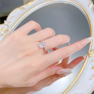 Detailed view of radiant cut rectangular gemstone ring with silver band in mirror reflection