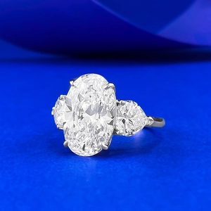 Three-stone S925 silver ring featuring a large oval centerpiece and pear-cut side diamonds