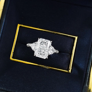 Macro shot of a 5-carat rectangular cut white diamond ring with side pear-shaped stones