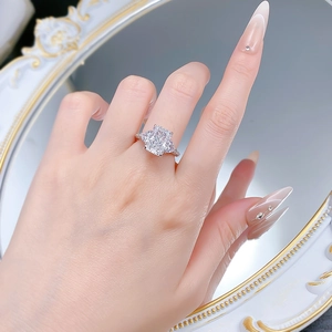 Macro detail of S925 silver ring featuring 5-carat ice-cut radiant center stone and side gems