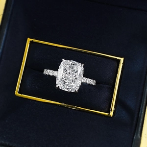 Cushion-cut 5-carat sparkling diamond ring in silver setting presented in a velvet gift box
