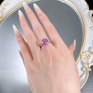 Close-up of elegant S925 silver ring with a large pink oval gemstone on hand