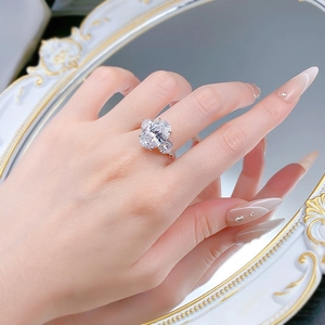 Detailed view of an oval cut large stone ring with side stones on a model's hand