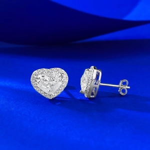 Macro side view of heart-shaped S925 silver stud earrings with diamond halo and butterfly back