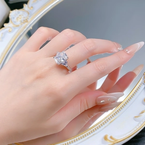 Macro shot of 5ct cushion-cut high carbon diamond ring with side trillion stones and pavé band