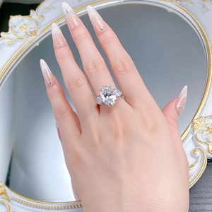 Close-up of S925 silver ring with large oval-cut gemstone and side stones worn on hand