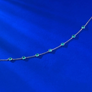 S925 silver bracelet with green bezel-set gemstones shown from a diagonal view