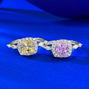 Dual S925 silver rings featuring square halo-set yellow and pink gemstones on blue surface