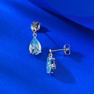 Macro shot of S925 sterling silver stamp on pear cut light blue drop earrings