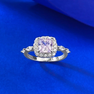 Detail of S925 sterling silver ring with princess cut pink gem in halo setting