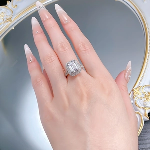 Gros plan détaillé d'une bague taille émeraude avec anneau fendu sur une main