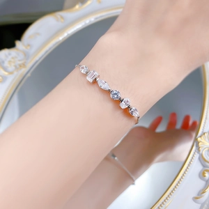 Detail of S925 silver bracelet featuring multi-shape crystals on a reflective surface