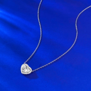 Elegant S925 silver heart pendant necklace with shimmering zircon stones on blue background