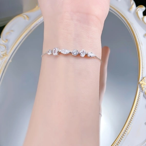 Detail of silver S925 bracelet with multi-shape zircon stones worn on wrist