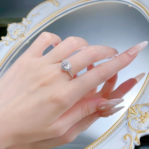 Gros plan d'une bague en argent S925 avec diamant taille cœur et sertissage halo