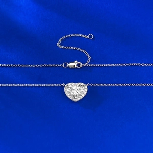 Macro shot of S925 silver heart necklace with halo setting on blue velvet backdrop