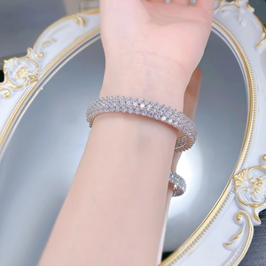 Close-up of a luxury multi-row full pave diamond bracelet worn on a female wrist