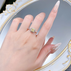 Detail of S925 silver ring featuring a halo-set square yellow gem with pavé side stones