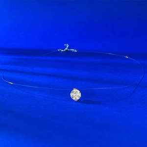 Macro shot of single brilliant-cut zircon pendant with invisible fishing line chain