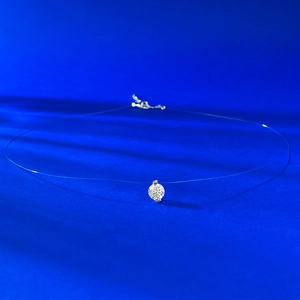 Detail of invisible fishing line necklace with a sparkling round zircon solitaire pendant