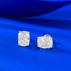 Macro detail of cushion-cut solitaire stud earrings with four-prong silver setting