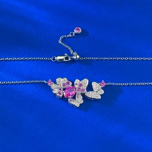 S925 silver butterfly necklace with a pink oval gemstone on dark blue silk fabric