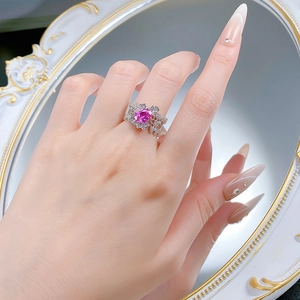 Detail showing an S925 silver lace ring with an oval pink gemstone on a model's hand