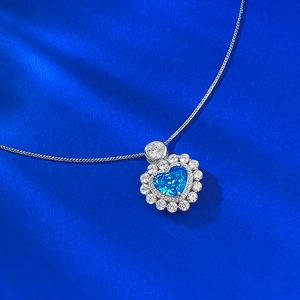 Elegant S925 silver necklace featuring a heart-cut aquamarine pendant on blue silk