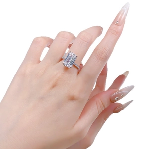 Emerald cut rectangle zircon ring with pave setting on silver band shown on hand